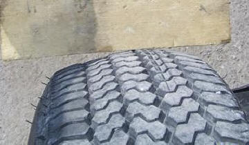 Tire tread bulge before a blowout.